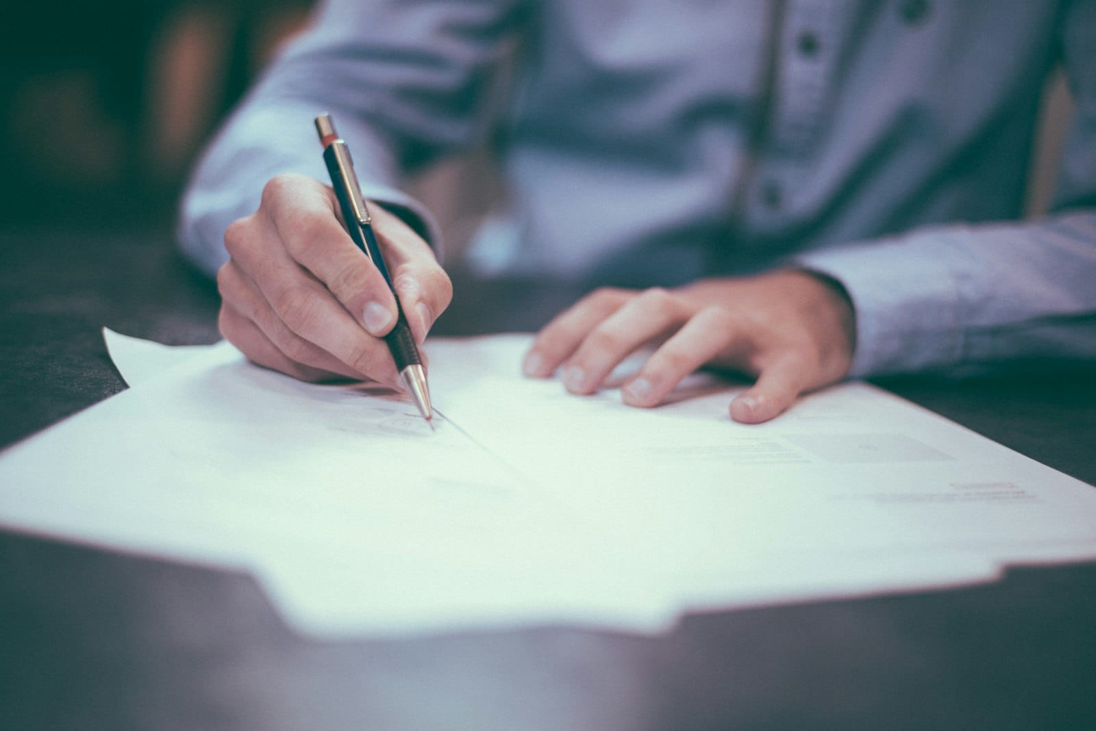 A finance professional signing an official document