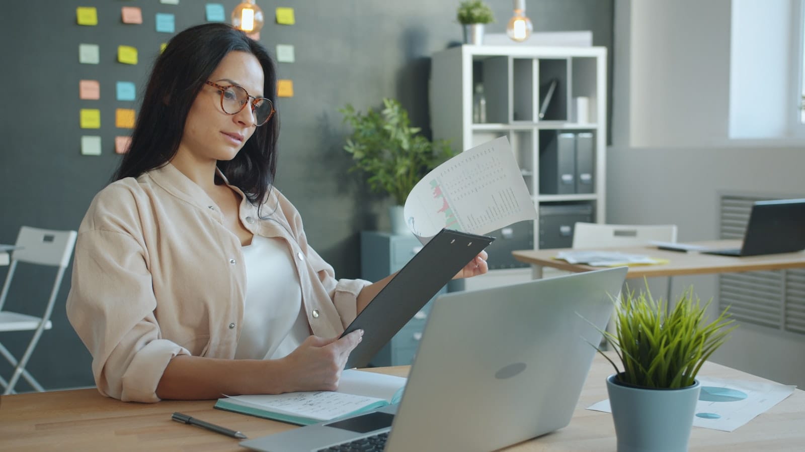 A professional reviewing a security report at her desk
